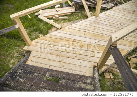 New wooden stairs outdoors. Carpenters work. New wooden stairs outdoors. Carpenters work. 132551775