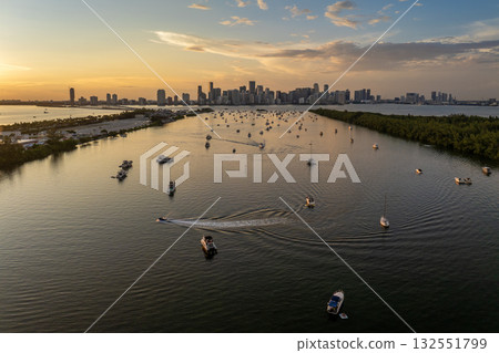 Miami, Florida. Biscayne Bay harbor with many yachts and motor boats. Enjoying sunset over city skyline with high-rise buildings in downtown 132551799