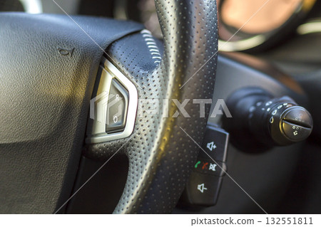 Luxurious car interior. Dashboard and steering wheel in black gray color. Transportation, design, modern technology concept.ultiple Values) Luxurious car interior. Dashboard and steering wheel in black gray color. Transportation, design, modern technology concept.ultiple Values) 132551811