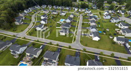 Low-density two story private homes in rural residential suburbs outside of Rochester, New York. Upscale suburban houses with large lot size and green grassy lawns in summer season 132551815