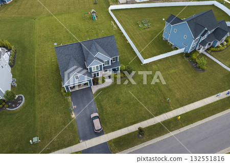 Low-density two story private homes in rural residential suburbs outside of Rochester, New York. Upscale suburban houses with large lot size and green grassy lawns in summer season Low-density two story private homes in rural residential suburbs outside of Rochester, New York. Upscale suburban houses with large lot size and green grassy lawns in summer season 132551816