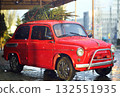 red retro car with a Christmas tree on the roof against the background of falling snow. 132551935