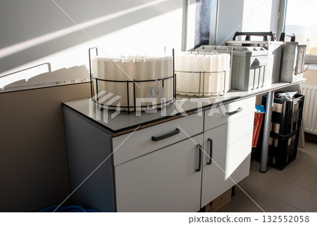 Blue plastic storage boxes on a laboratory counter.Automatic wastewater sampler equipment in laboratory setting. 132552058