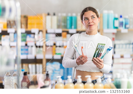 Woman choosing a set of dental nets at the pharmacy 132553160