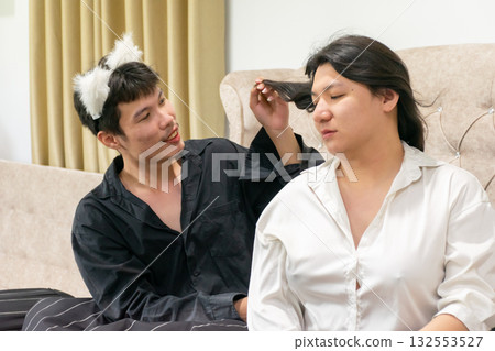 Two Thai LGBTQ friends sharing a morning moment together showing warmth connection and acceptance representing love diversity and gentle lifestyle in a cozy bedroom atmosphere 132553527