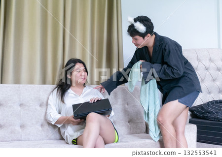 Two Thai LGBTQ friends spending morning together one encouraging the other to take a shower showing friendship care diversity and real life connection at home 132553541