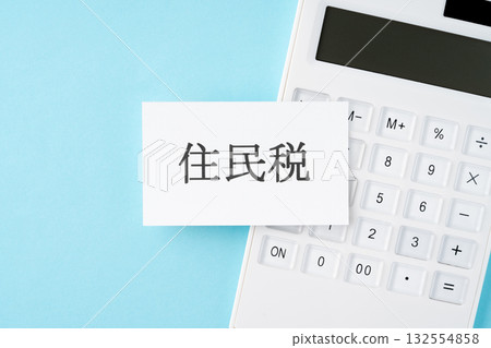 Resident tax text and calculator on a light blue background Resident tax text and calculator on a light blue background 132554858