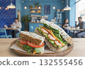 Shrimp, avocado, vegetable sandwich and tomato sandwich on a cafe table 132555456