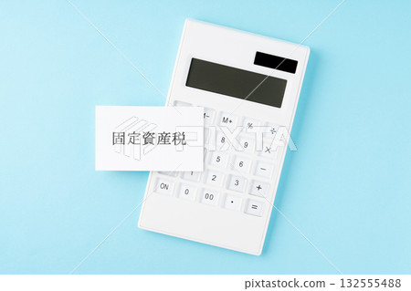 Property tax lettering and calculator on a light blue background 132555488