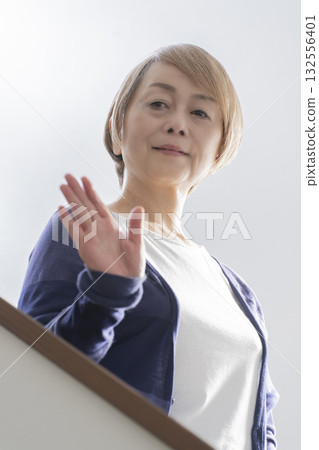 Senior woman with knee pain from going up and down stairs 132556401