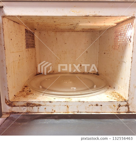 Dirty Microwave Interior with Food Stains and Grease in Kitchen Appliance Dirty Microwave Interior with Food Stains and Grease in Kitchen Appliance 132556463