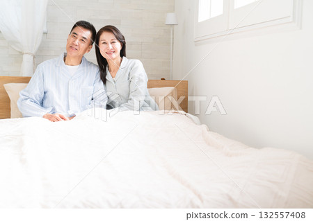 A couple waking up and having a conversation in bed 132557408