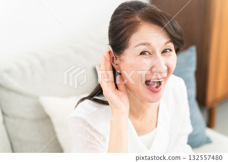 Mature woman wearing a hearing aid 132557480