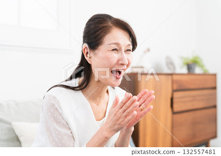 Mature woman wearing a hearing aid 132557481