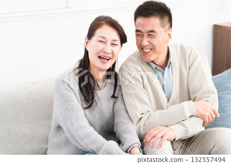Mature couple sitting on the sofa Lifestyle image 132557494