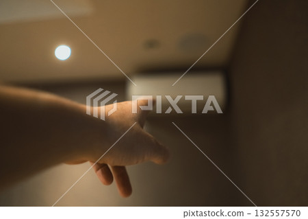 Pointing at a home air conditioner 132557570