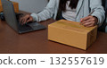 E-commerce: Individual labeling packages while using a laptop 132557619