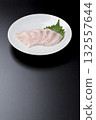 Sawara sashimi served on a plate against a black background 132557644