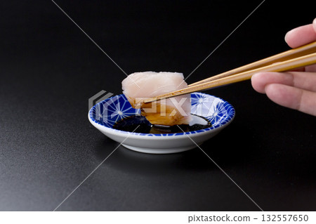 Sawara sashimi served on a plate against a black background Sawara sashimi served on a plate against a black background 132557650