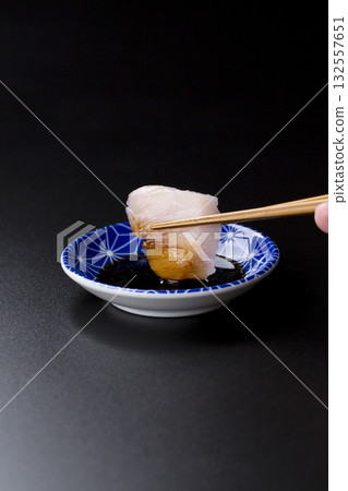 Sawara sashimi served on a plate against a black background Sawara sashimi served on a plate against a black background 132557651