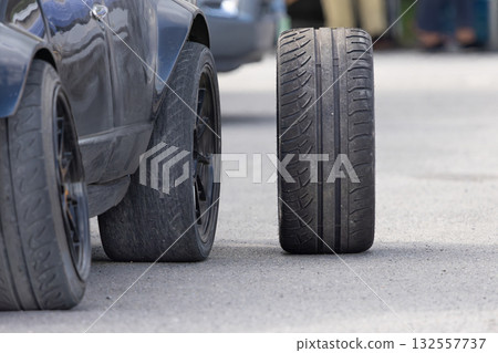 New Car Drifting Tires and Worn-Out Tire in Service Pits. Drift race car in service area. New Car Drifting Tires and Worn-Out Tire in Service Pits. Drift race car in service area. 132557737