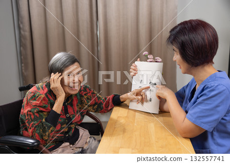 Elderly Woman with Dementia Practicing Call Animal Name Pictures. Elderly Woman with Dementia Practicing Call Animal Name Pictures. 132557741