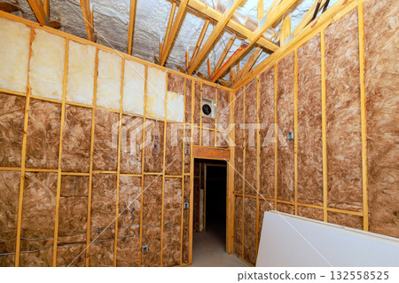 Rooms are in midst of renovation, beams framing insulation materials at building project. 132558525