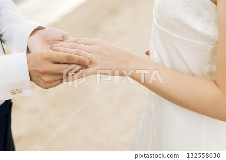 A man's hand wearing a finger on a female A man's hand wearing a finger on a female 132558630