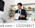 Real Estate Agent Presenting Contract to Client 132558817