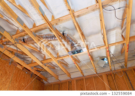 Ventilation ducts insulation are being installed in residential building during renovations. Ventilation ducts insulation are being installed in residential building during renovations. 132559084