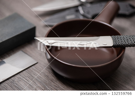 Knife sharpening with whetstone Knife sharpening with whetstone 132559766