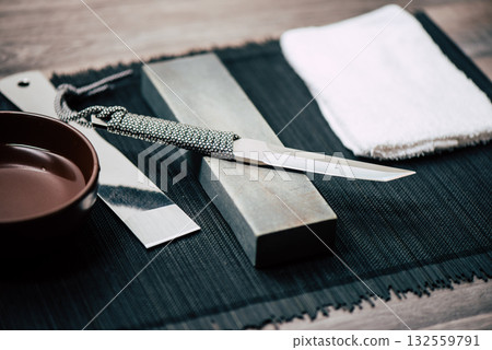 Knife sharpening with whetstone 132559791