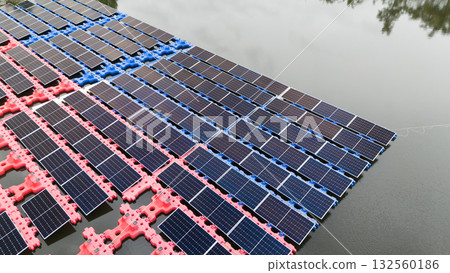 Drone view of Floating Solar Panel. Solar photovoltaic panel PV System in Industry lake water pond Drone view of Floating Solar Panel. Solar photovoltaic panel PV System in Industry lake water pond 132560186