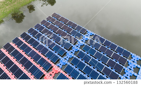 Drone view of Floating Solar Panel. Solar photovoltaic panel PV System in Industry lake water pond Drone view of Floating Solar Panel. Solar photovoltaic panel PV System in Industry lake water pond 132560188