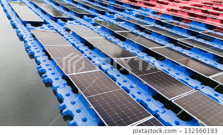 Drone view of Floating Solar Panel. Solar photovoltaic panel PV System in Industry lake water pond Drone view of Floating Solar Panel. Solar photovoltaic panel PV System in Industry lake water pond 132560193