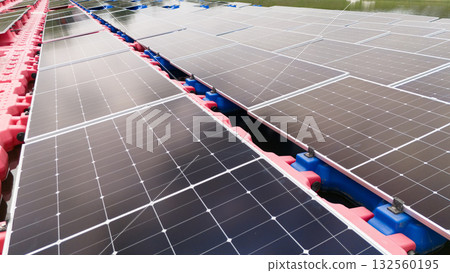 Drone view of Floating Solar Panel. Solar photovoltaic panel PV System in Industry lake water pond Drone view of Floating Solar Panel. Solar photovoltaic panel PV System in Industry lake water pond 132560195