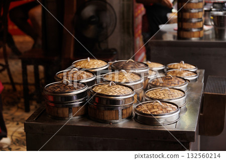Chinese hot steam cooking food Yumcha or Dim sum in Bamboo Steamer Basket at Chinese restaurant 132560214