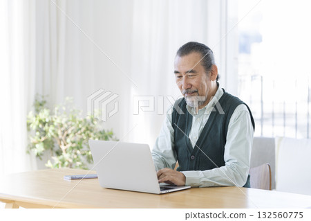 A man in his 70s working on a laptop A man in his 70s working on a laptop 132560775