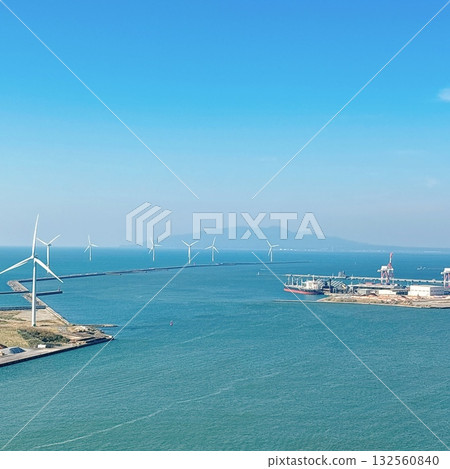 A view of the port and wind turbines lined up under a blue sky A view of the port and wind turbines lined up under a blue sky 132560840