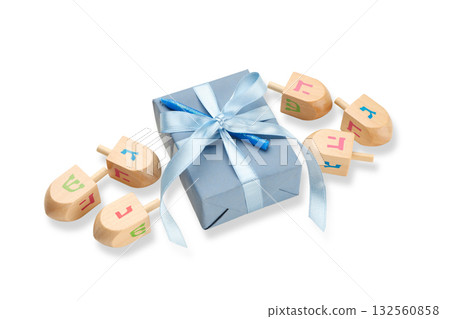 Gift box with blue ribbon and wooden dreidels, isolated, PNG 132560858