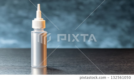 Cartridge of mounting adhesive with nozzle standing upright, professional construction product shot 132561050