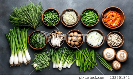 Traditional Korean dining table showcasing an array of seafood, fresh vegetables, and mushrooms in a warm home setting 132561841