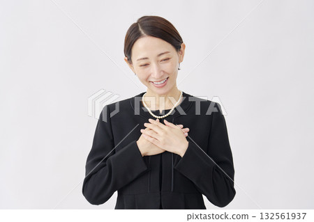 A woman in mourning clothes stroking her chest, white background 132561937
