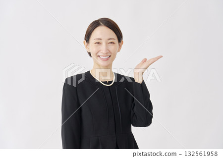 Woman in mourning clothes pointing to the right, white background 132561958