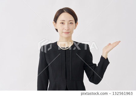 Woman in mourning clothes pointing to the right, white background Woman in mourning clothes pointing to the right, white background 132561963