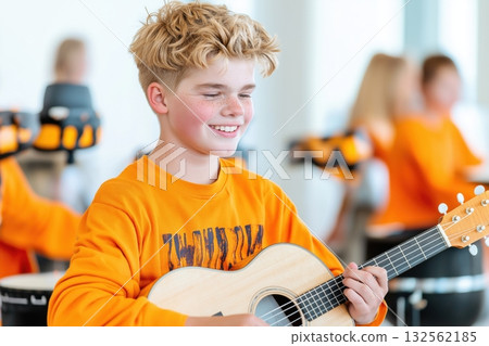 Young person with developmental disabilities enjoys music therapy session playing instrument in inclusive environment 132562185