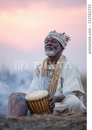 African elder performing a spiritual ritual, seated with traditional drums, surrounded by smoke and nature, capturing the essence of cultural heritage and spiritual connection African elder performing a spiritual ritual, seated with traditional drums, surrounded by smoke and nature, capturing the essence of cultural heritage and spiritual connection 132562252