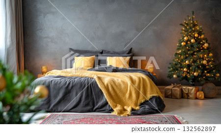 A cozy, festive bedroom features a bed with dark grey bedding and bright yellow accents. A lit Christmas tree is on the right, surrounded by presents and lanterns A cozy, festive bedroom features a bed with dark grey bedding and bright yellow accents. A lit Christmas tree is on the right, surrounded by presents and lanterns 132562897
