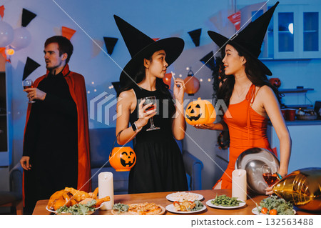 Joyful office Halloween party with coworkers in costumes, celebrating with drinks and laughter, fostering teamwork and festive spirit Joyful office Halloween party with coworkers in costumes, celebrating with drinks and laughter, fostering teamwork and festive spirit 132563488
