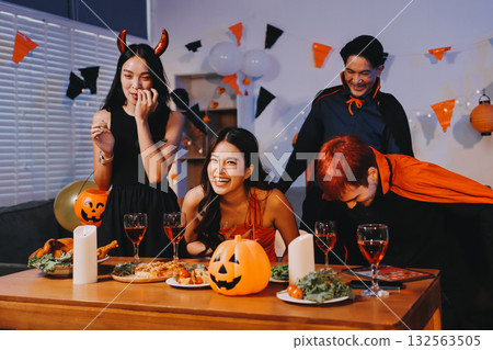 Joyful office Halloween party with coworkers in costumes, celebrating with drinks and laughter, fostering teamwork and festive spirit 132563505